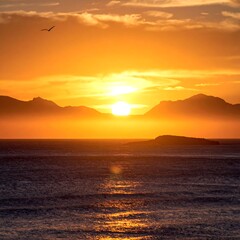 Golden sunset over misty mountains