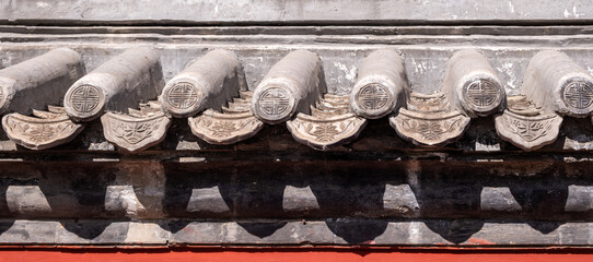 Traditional Chinese roof edge close-up, old ceramic roofing tiles background.