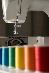 A vibrant array of sewing threads neatly aligned,showcasing a spectrum of colors for design and textile work