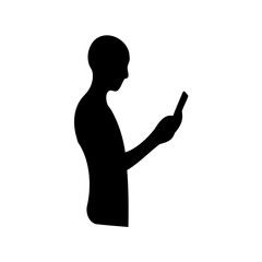 Silhouette of a person looking at a mobile phone in their hand