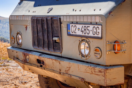 9 August 2025, Kopaonik, Serbia: Old military truck front view showing its rusty bumper, headlights, grille, and Kosovo license plate