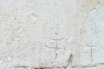 A white old wall with barillefs of stucco. Stone Texture Background with Patterns and Barillefs