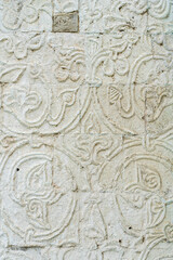 A white old wall with barillefs of stucco. Stone Texture Background with Patterns and Barillefs