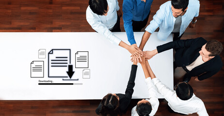 A business team collaborates in an office setting, symbolizing teamwork and partnership as they engage in a digital document downloading process together. Trope