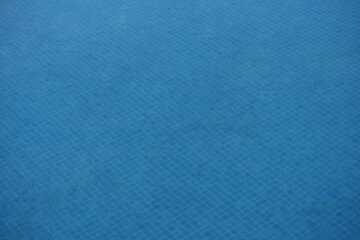 Light blue ceramic tiles in a swimming pool, arranged in a square mosaic pattern. The bright aqua shade enhances the effect of clear water, creating a fresh and tropical atmosphere. Ideal for modern p