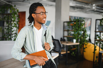 African american medical student holding book in university
