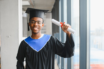 Happy african american medical student showing diploma after graduation ceremony