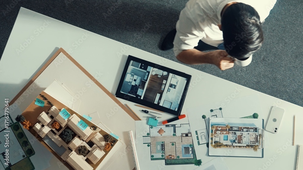 Poster top down view of skilled business man and colleague design house together. aerial view of architect 