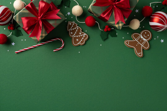 A festive Christmas scene featuring wrapped gifts, gingerbread cookies, a candy cane, and decorative elements on a green backdrop for holiday celebrations
