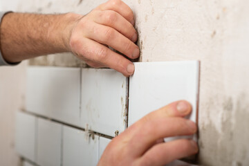 repair and lay white tiles in the kitchen independently