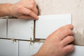 repair and lay white tiles in the kitchen independently