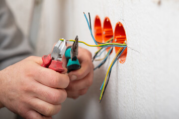 insulation of electricity in sockets, hands in close-up