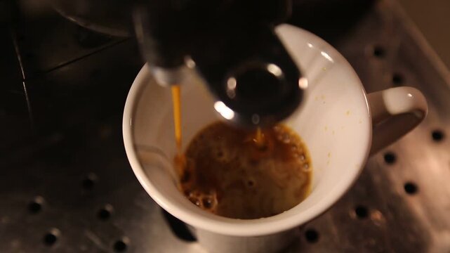 Coffee machine pours coffee into a cup with natural sound. Espresso coffee maker filling a cup