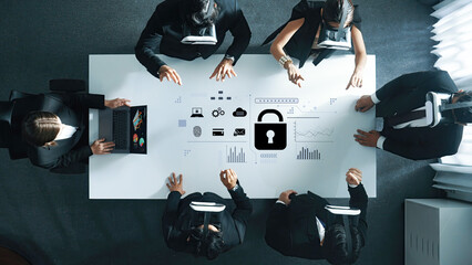 The image shows a team of business professionals wearing virtual reality headsets, working...