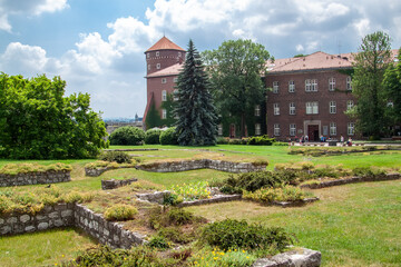 Historic Wawel Royal Castle grounds in Krakow, Poland, featuring ancient stone foundations,...