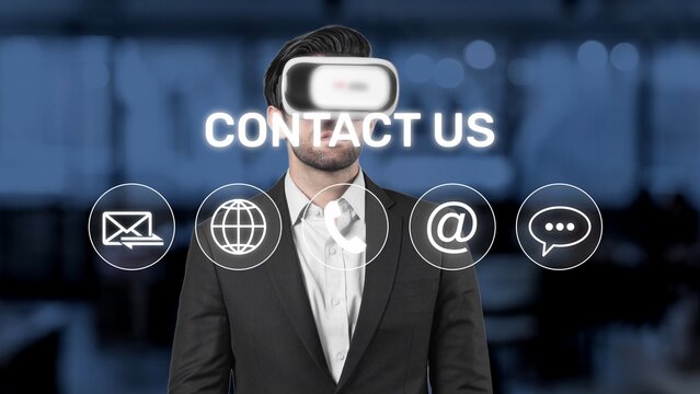 A businessman wearing a virtual reality headset stands in a modern office, surrounded by contact icons. This image represents advanced technology and user engagement strategies. Raster