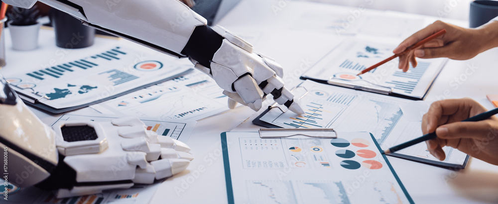 Poster a futuristic robot hand interacts with human hands over business reports filled with charts and grap