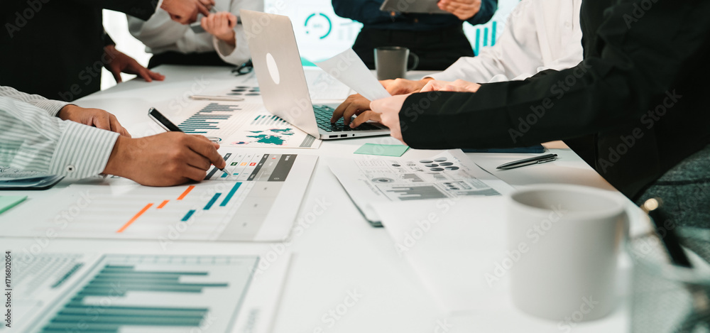 Poster a dynamic business meeting takes place as professionals analyze charts and data, collaborating on st