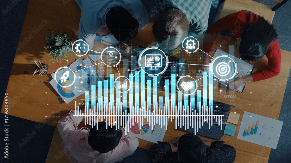 Poster a top view of a diverse team engaged in a productive business meeting, analyzing data trends and col