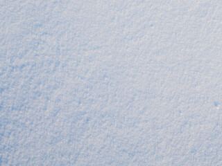 Natural snow texture. The surface of clean fresh snow. Snowy ground. Winter background with snow patterns. Perfect for Christmas and New Year design. Closeup top view.