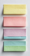 Fototapeta premium Stack of colorful, pastel sticky notes in yellow, pink, purple, and green