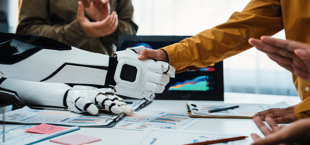 Poster a human and robot shake hands in a modern workspace, showcasing collaboration and innovative technol