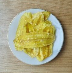 Top view shows crispy Thai banana chips, a popular and delicious agricultural product made from thinly sliced bananas fried to perfection.