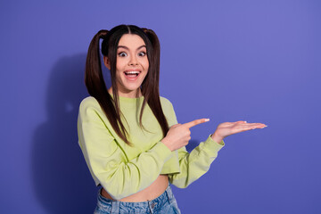 Young woman gesturing excitedly against a colorful background, showcasing a cheerful expression, fashion style, and promotional concept