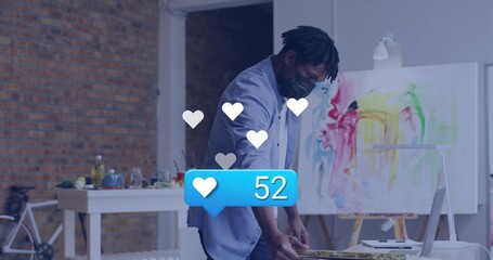 Painting male artist applying strokes in art studio, with canvas, palette, bicycle and media icons