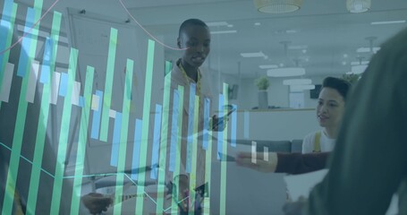 Collaborating team analyzing data around desk in office, with laptop smartphone report data overlay