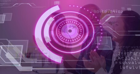 Clapping colleagues observing purple holographic interface in modern office, with laptops, pens