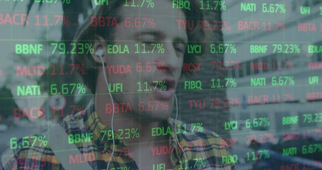 Glancing man wearing yellow plaid shirt on busy street with wired earphones, ticker overlay