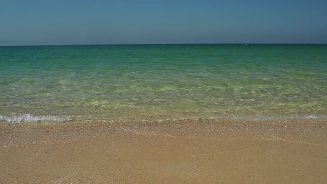 vedeo footage of calm ocean under a clear blue sky, with the horizon line stretching across the frame ideal for sea nature, relaxation, and travel themes and nature lovers.