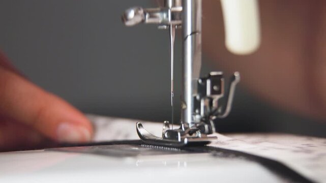 A seamstress working on a sewing machine at a table, close-up. Concept Focus on craftsmanship and dedication to the craft.