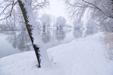 Landscape of a frozen river on a cloudy winter day.