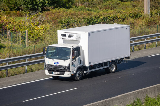 Danone isuzu refrigerated truck transporting goods on highway