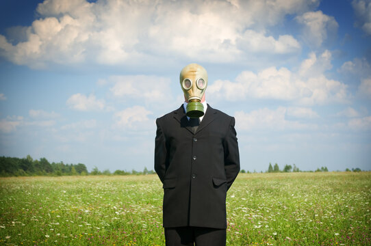 man in gas-mask on meadow.