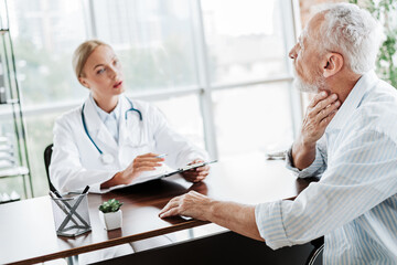 Fototapeta premium Patient discussing health concerns with a doctor during a medical consultation in a bright clinic office.