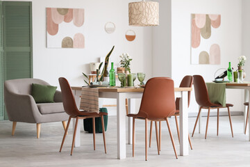 Interior of restaurant with tables, flowers and paintings