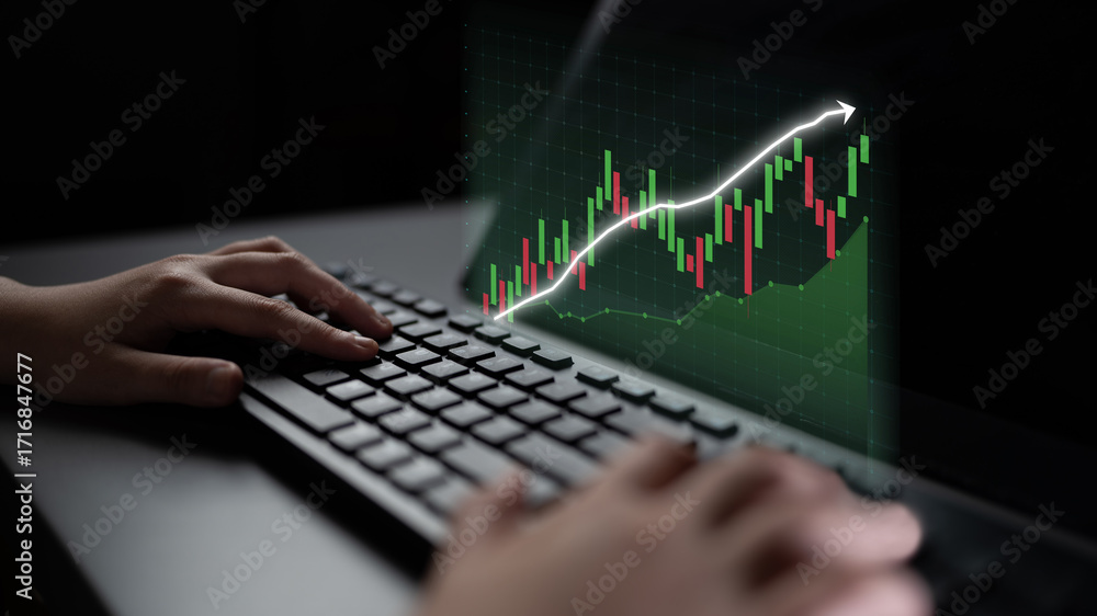 Poster a user interacts with a keyboard while analyzing financial data displayed on a screen, depicting an 