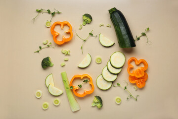 Composition with fresh vegetables and peas micro green on beige background, closeup