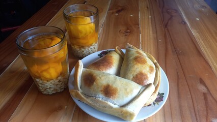 Empanadas and Mote with huesillo. Chilean food.