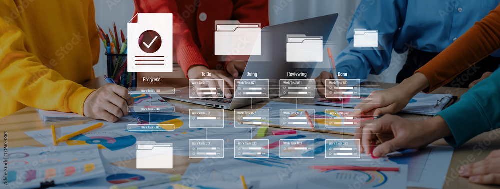 Aufkleber a diverse team collaborates around a laptop with digital tools and paper documents, focusing on proj