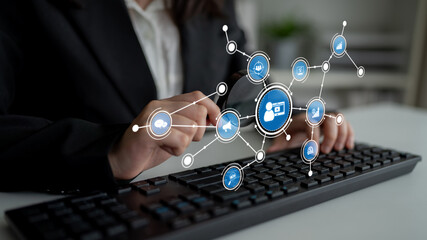 A business professional engages with a keyboard, surrounded by digital icons representing technology and networking, illustrating modern corporate communication. Tessel