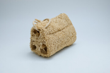 Natural loofah sponge on a clean white background. Perfect for illustrating eco-friendly bath accessories, zero waste lifestyle, personal care, and sustainable products.