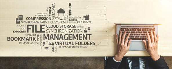 A businessman types on a laptop at a modern workspace, surrounded by key concepts related to file...