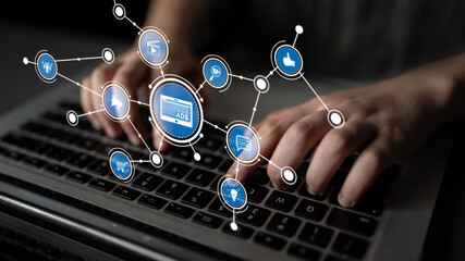 A close-up view of hands typing on a laptop keyboard, surrounded by digital marketing icons that represent online advertising and social media engagement strategies. Tessel