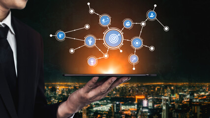 A businessman showcases a tablet displaying abstract digital network icons against a stunning city...