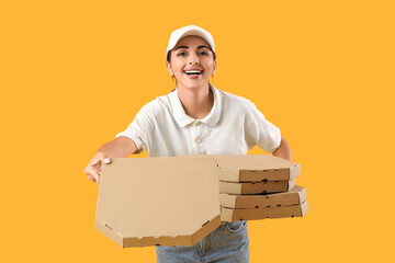 Female courier with pizza boxes on yellow background
