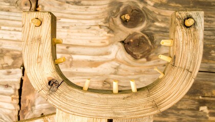 Rustic Wooden Tool with Pegs on Weathered Background